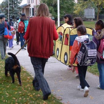 students and adults walking to school together
